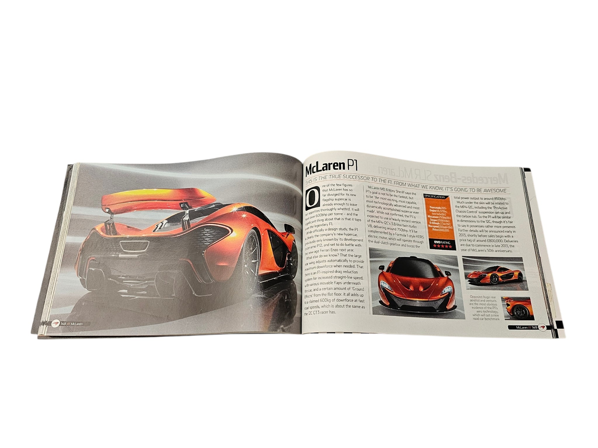 Supercar guide book open spread with orange McLaren P1 car image and text