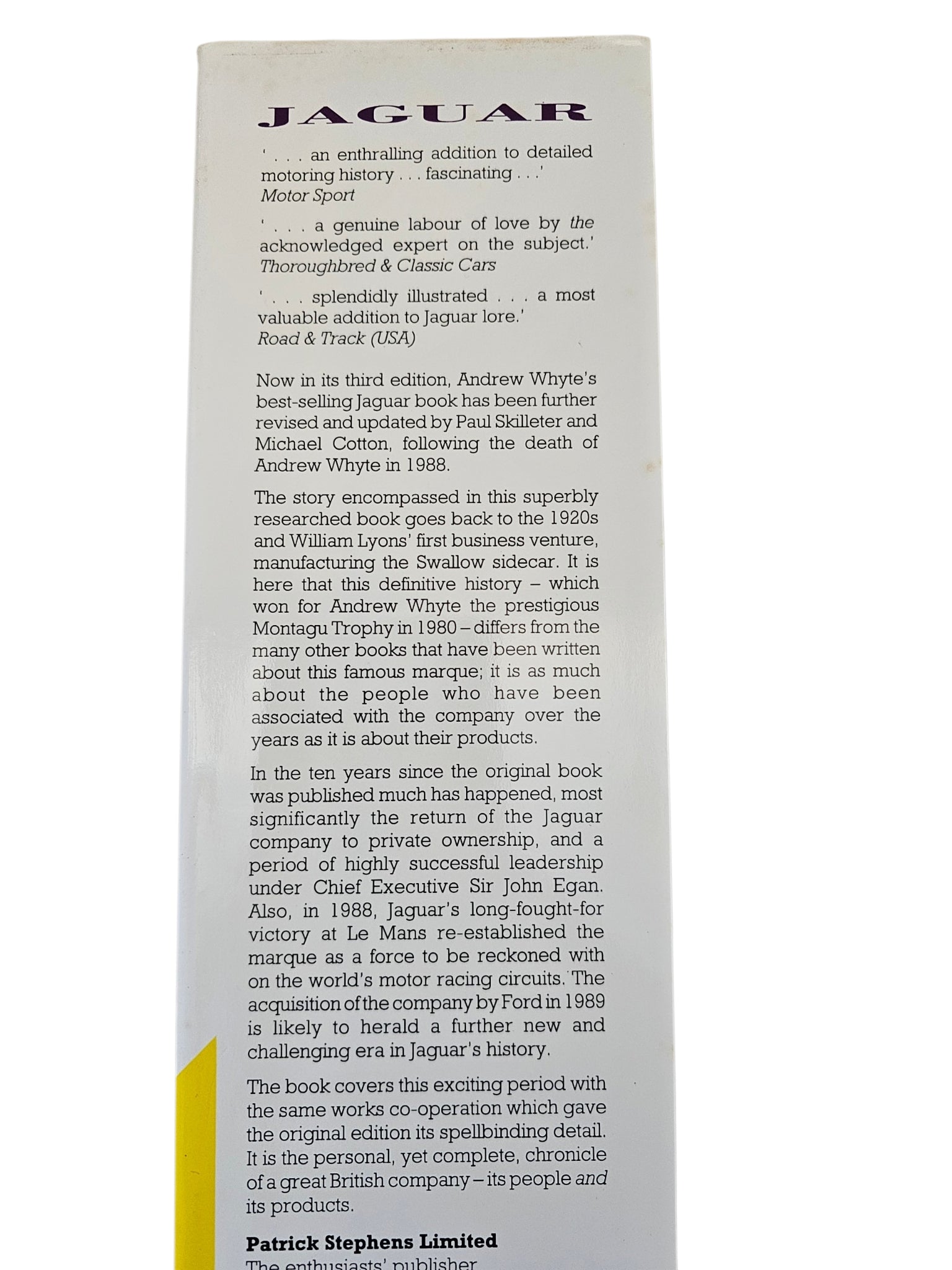 Car history book page with Jaguar title and long review-style text