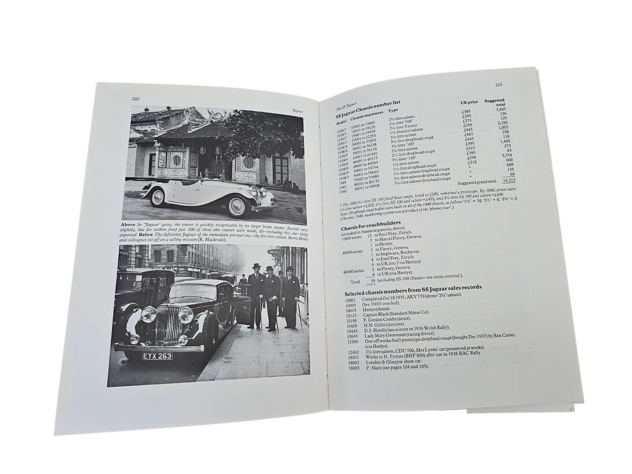 Open car history book with vintage car photos on pages and a table of entries