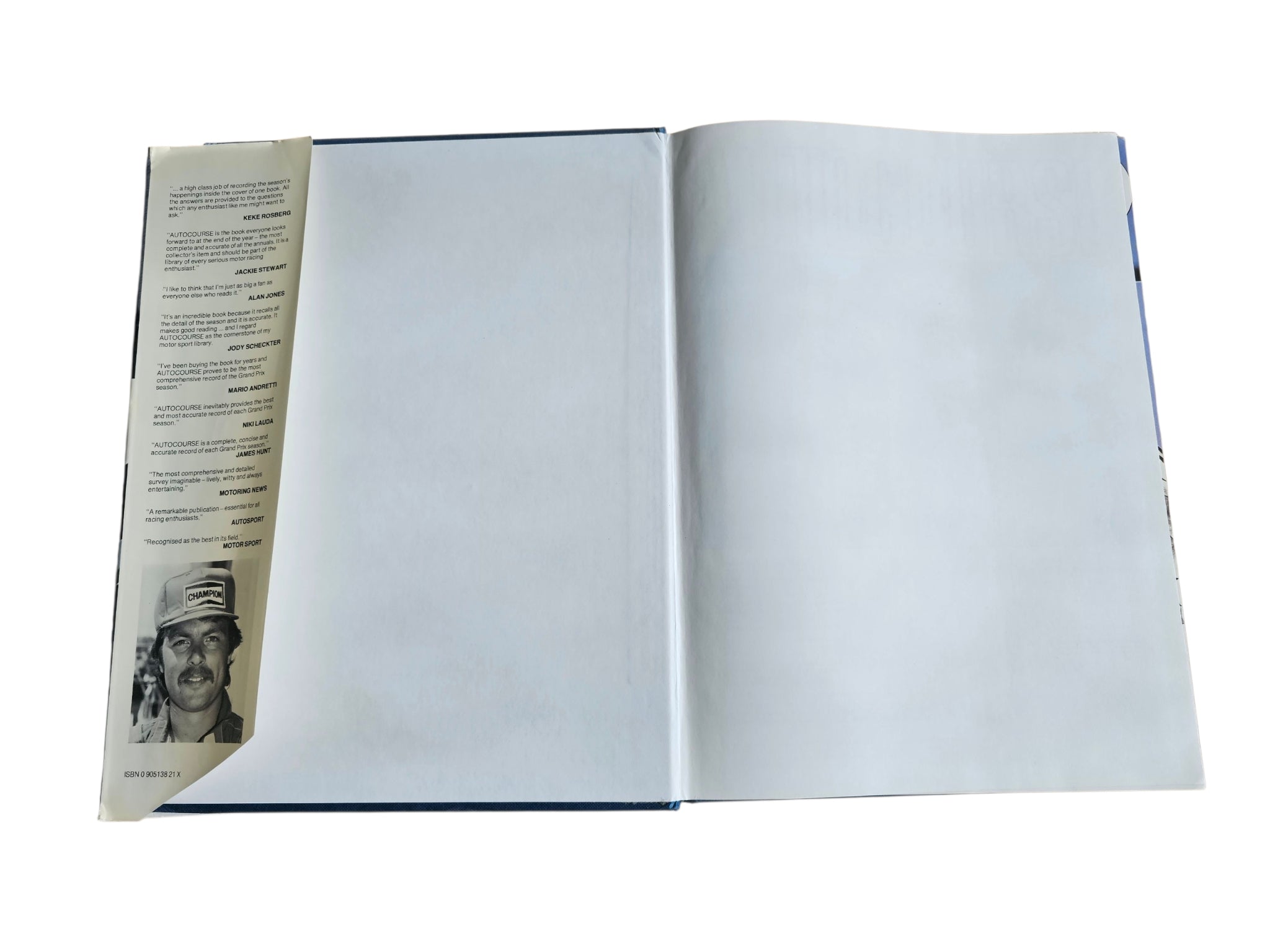 Open hardcover book with partial page sidebar and blank inner spread