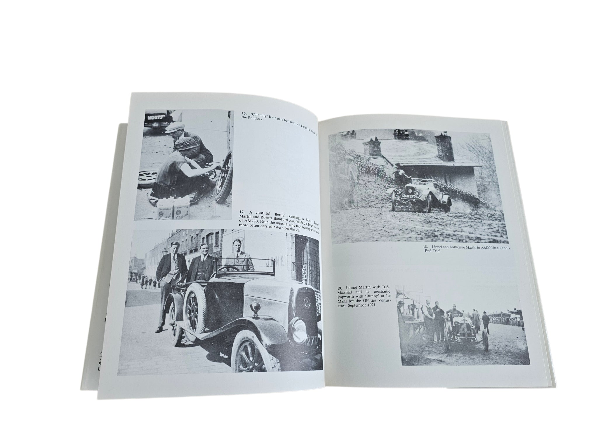 Hardcover biography book open to photo pages with vintage cars and people
