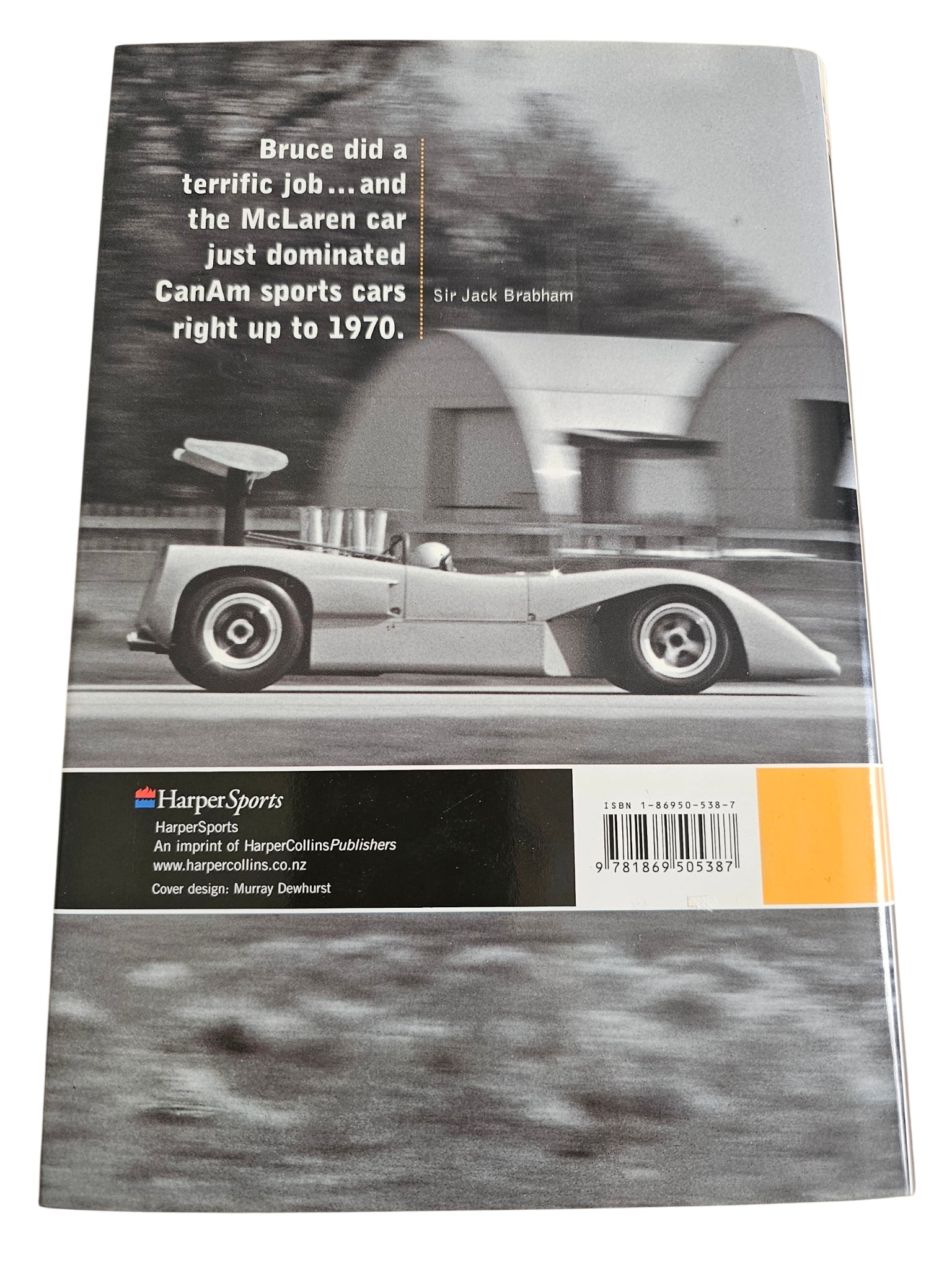 Signed motorsport biography book, back cover with race car photo and quote text