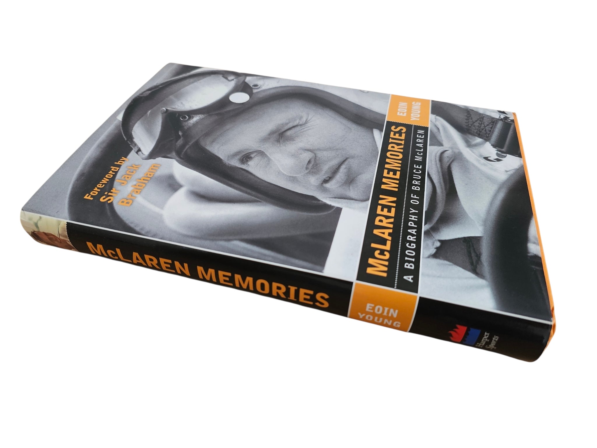Signed motorsport biography book, angled cover showing MCLAREN MEMORIES title on spine
