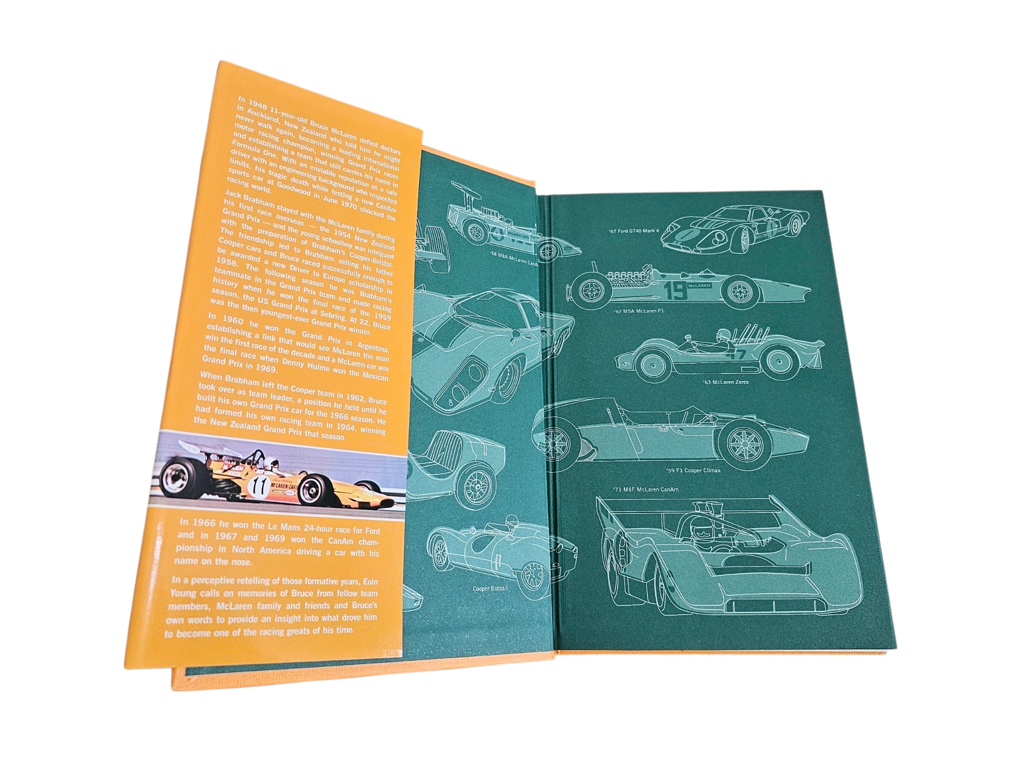 Open motorsport biography book, orange and teal spread with car line drawings