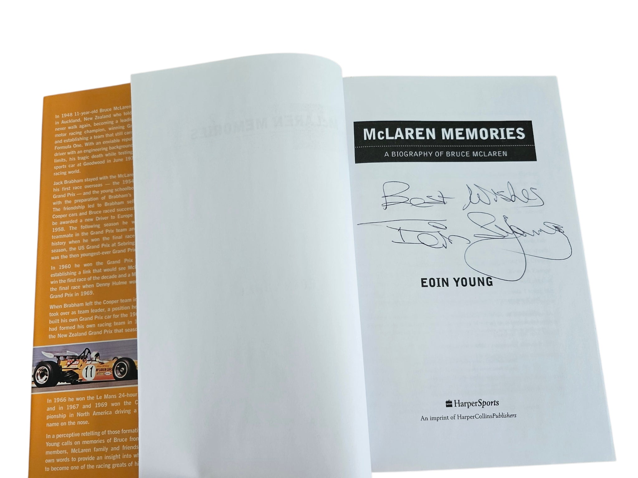 Open signed motorsport biography book, title page with author name and signature