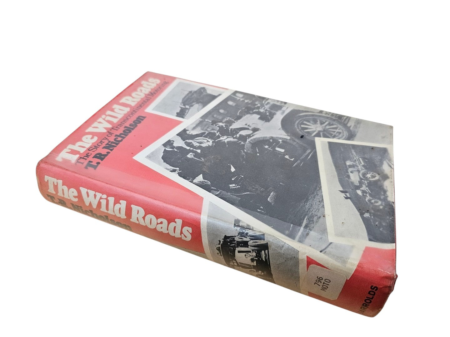 Red book with vintage motoring photos on the cover, shown from the side.