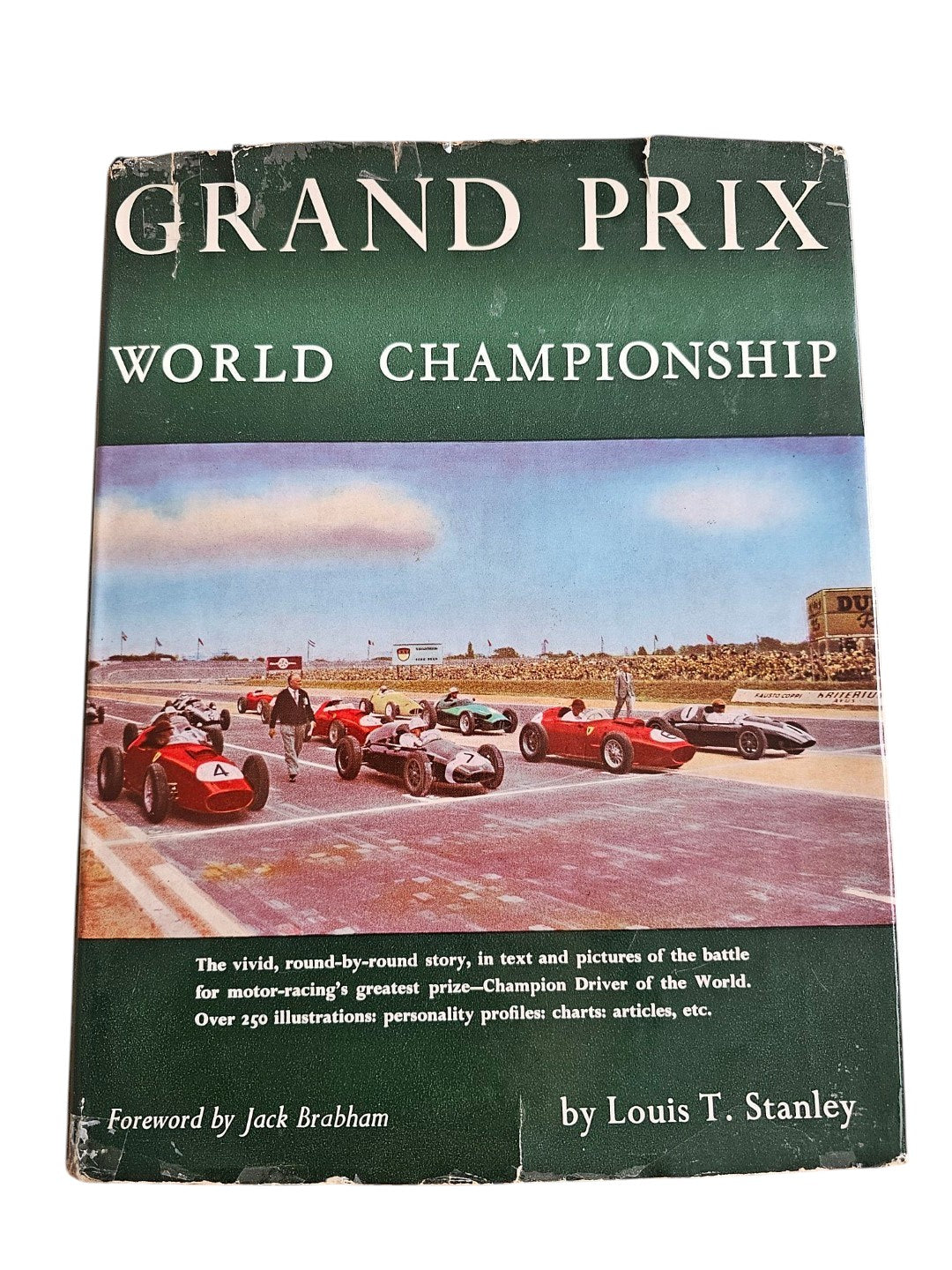 Vintage auto racing book, green cover titled “Grand Prix World Championship” by Louis T. Stanley.