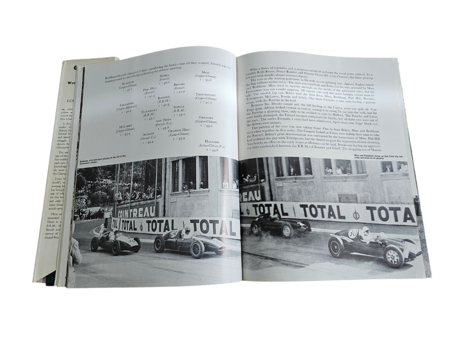 Vintage auto racing book open to two pages with black-and-white race photos and TOTAL tables.