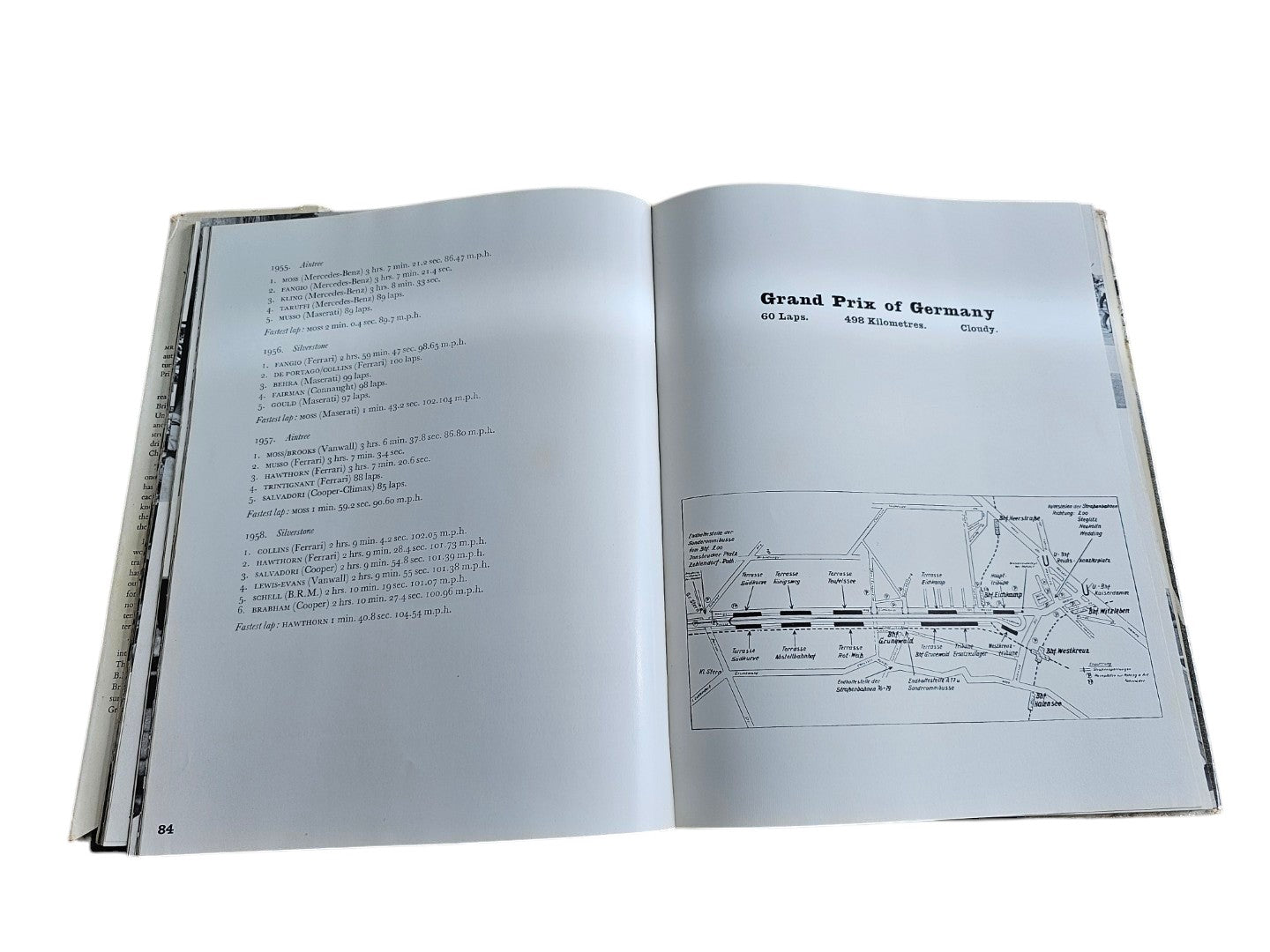 Vintage auto racing book open to pages with route map diagram and small captions.