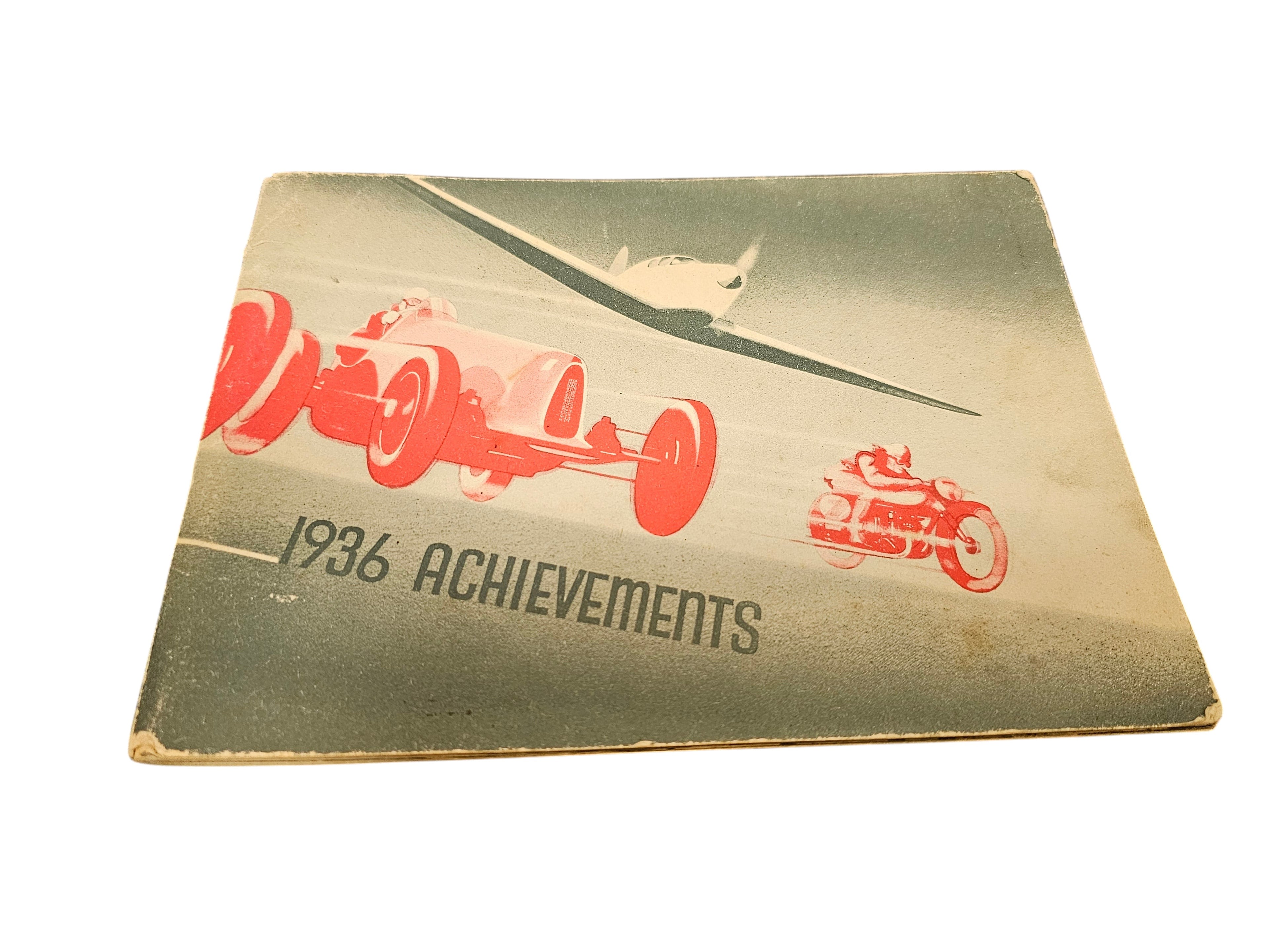 Vintage booklet cover with plane and red racing car, '1936 Achievements' text