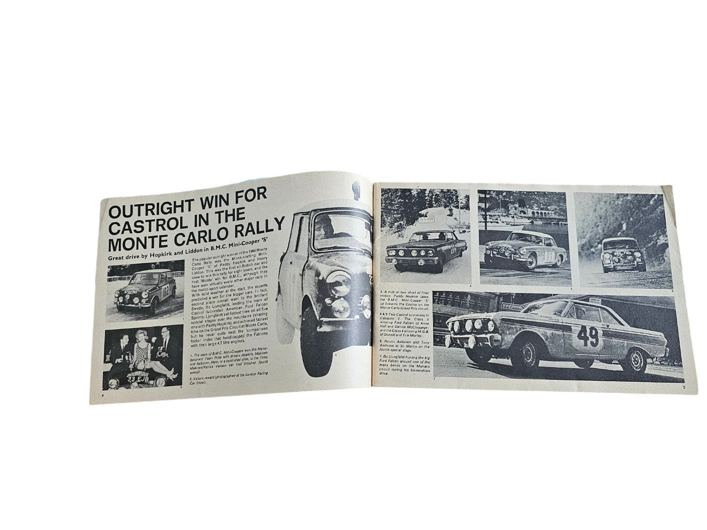Open vintage booklet pages with black-and-white car rally photos and a headline