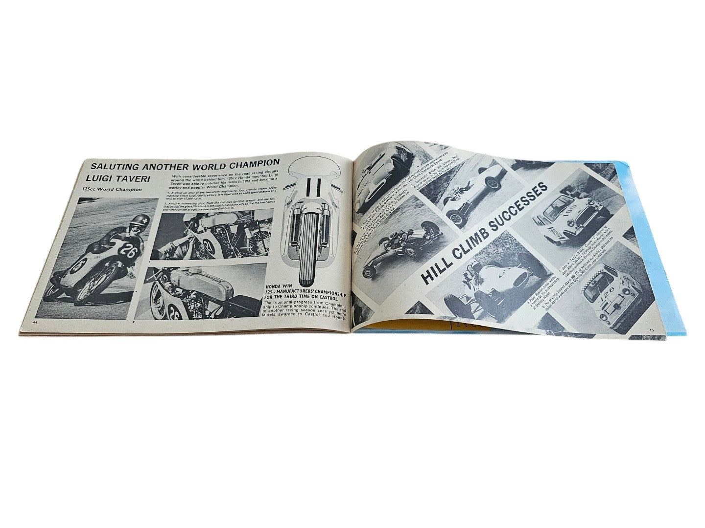 Open vintage booklet pages with black-and-white racing images and a small medal graphic