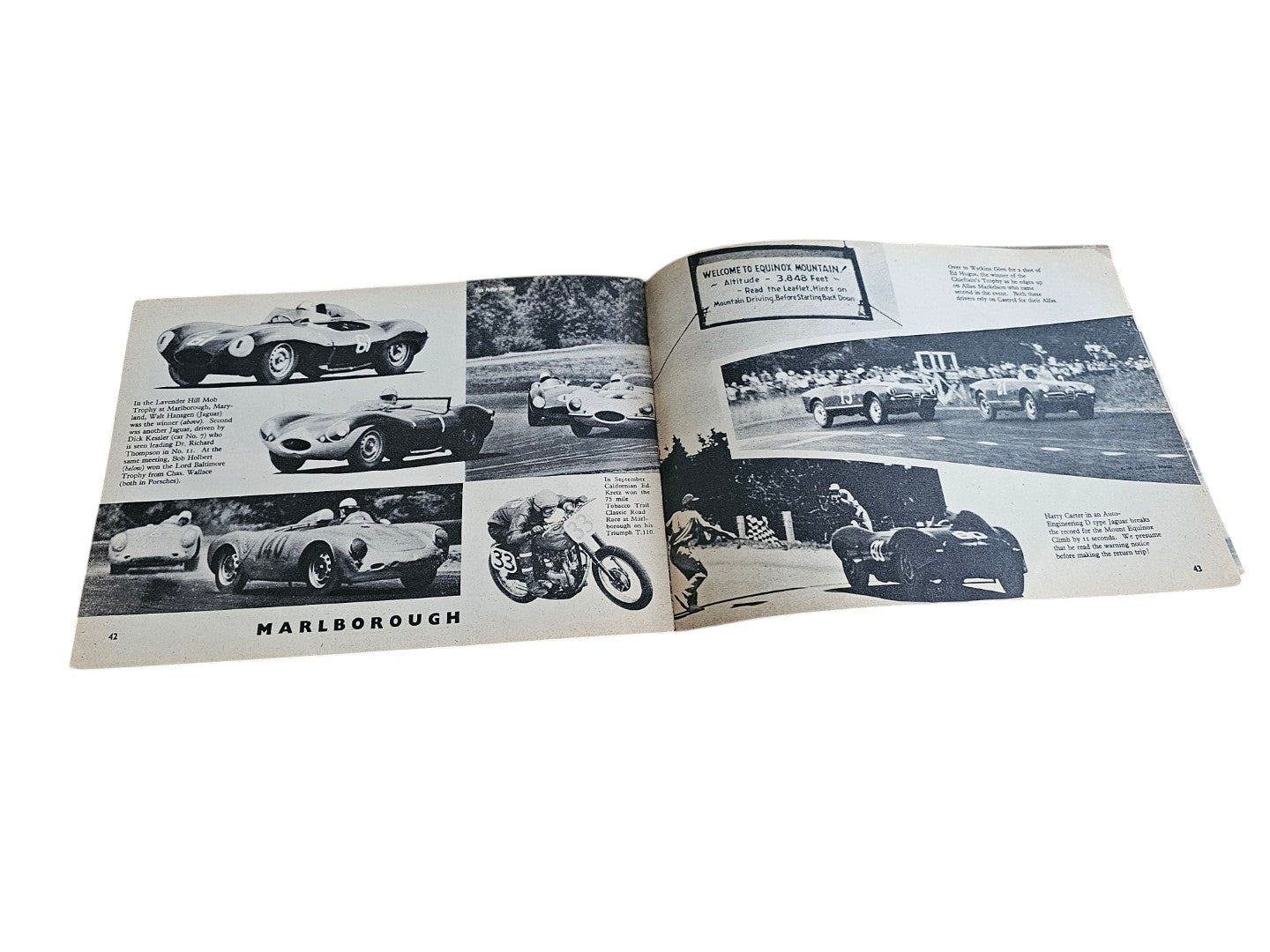 Open vintage racing book spread with black-and-white car and motorcycle photos
