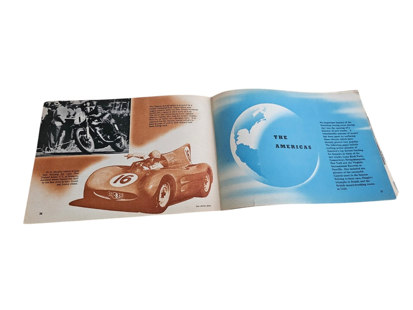 Open vintage racing book spread with a red race car and blue globe graphic