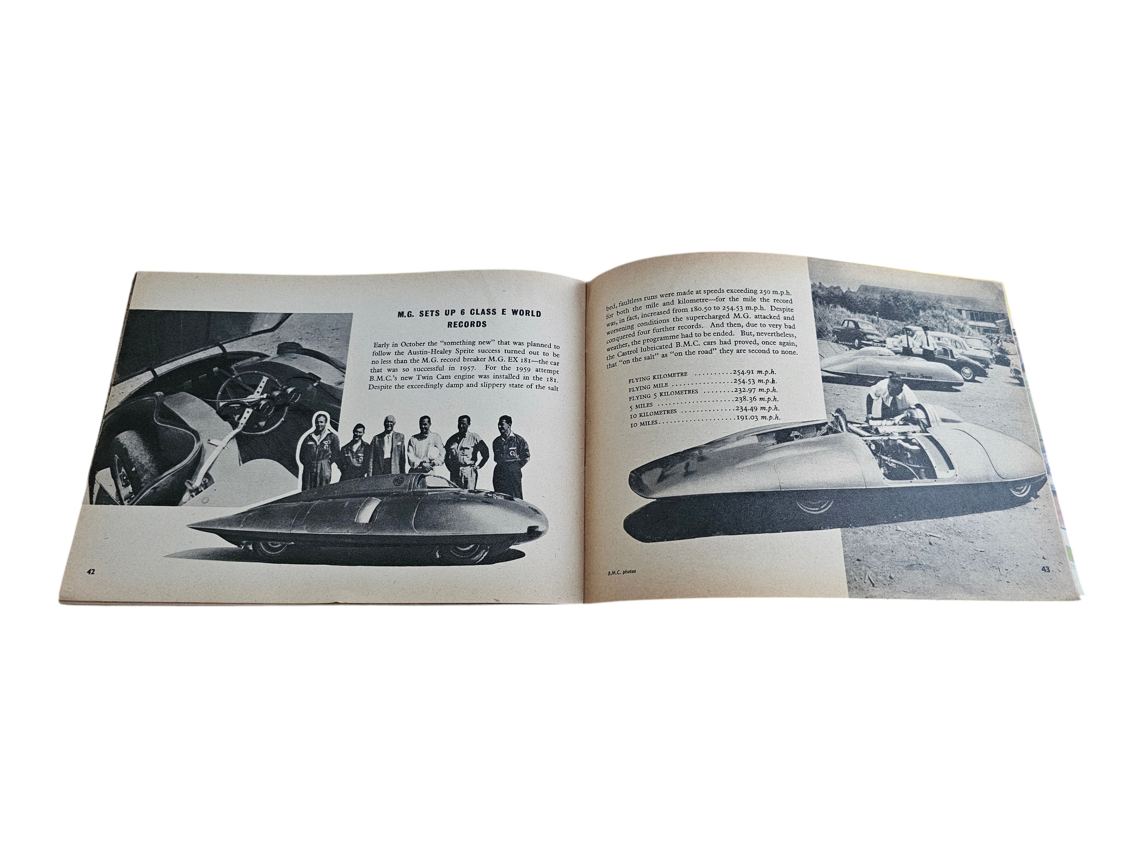 Open vintage racing book with black-and-white car cockpit close-up and photo captions