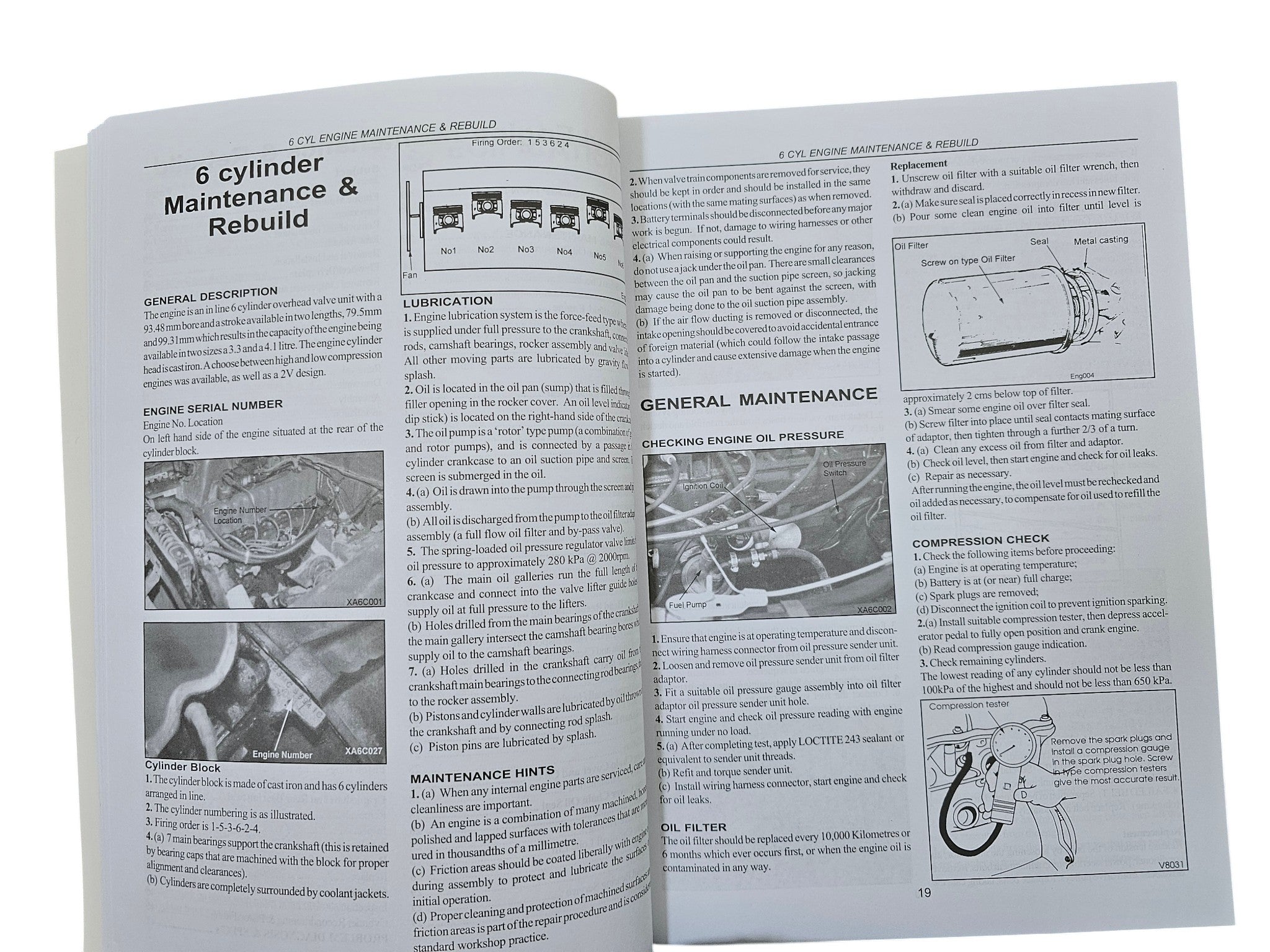 Workshop manual open engine maintenance pages with diagrams and instructions