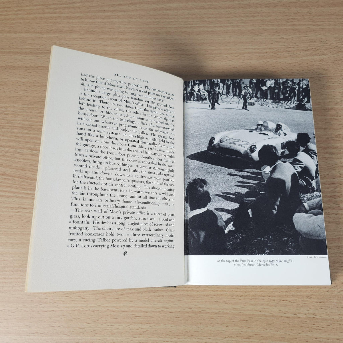 Open book spread with text and a black-and-white photo of a vintage race car