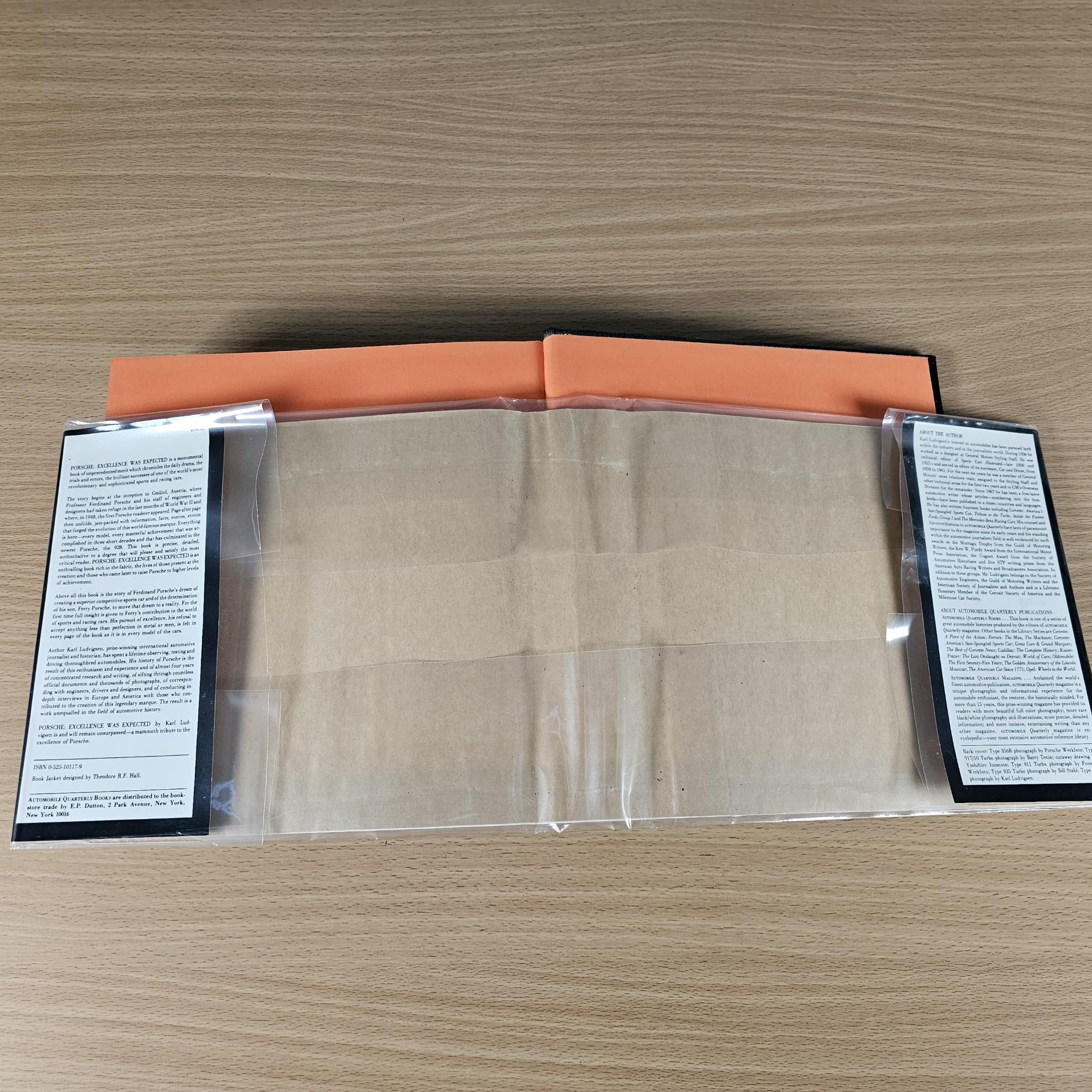 Open book with pale pages and orange borders, text blocks at both sides.