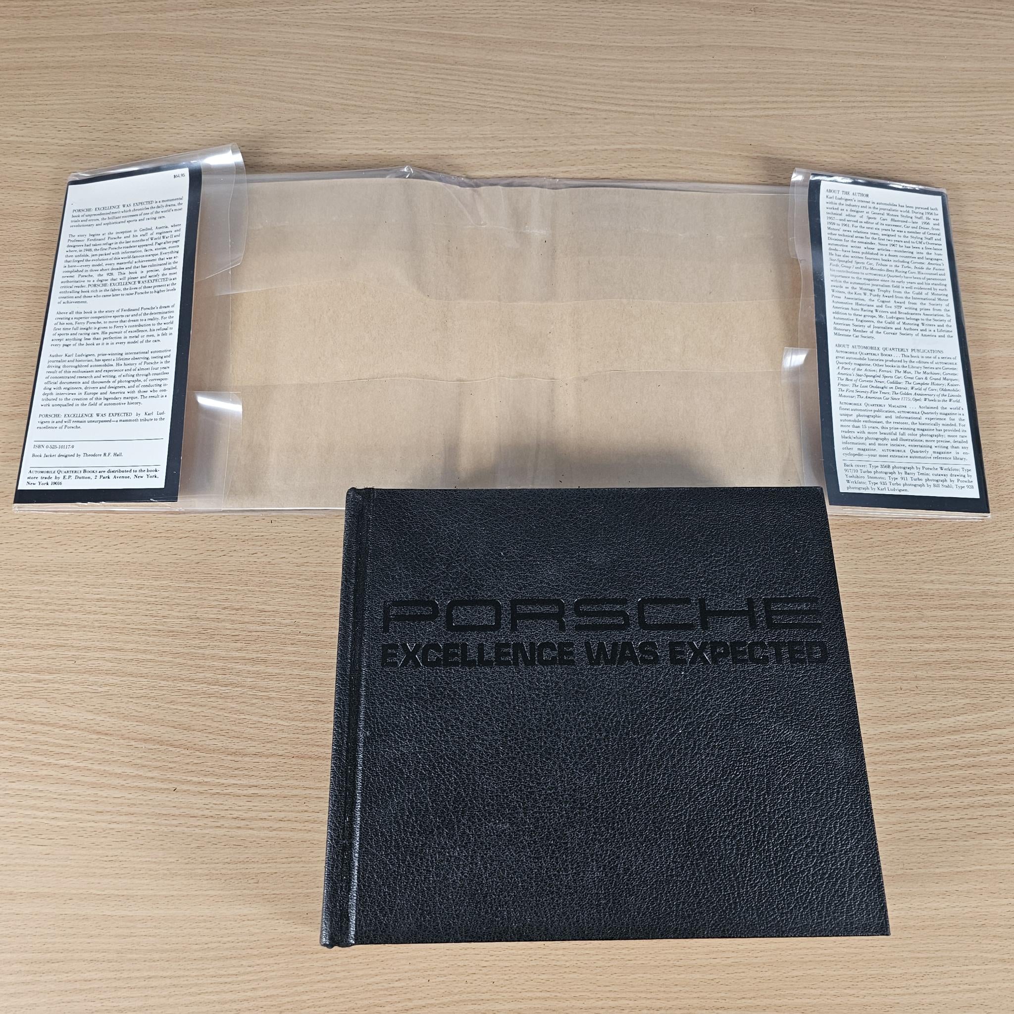 Hardcover book titled “PORSCHE EXCELLENCE WAS EXPECTED” with “Porsche” on cover.
