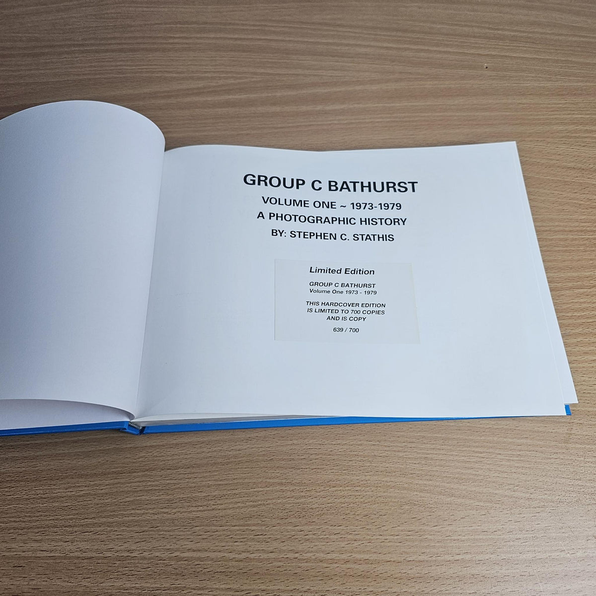 Open book with title text and limited edition details on a white page