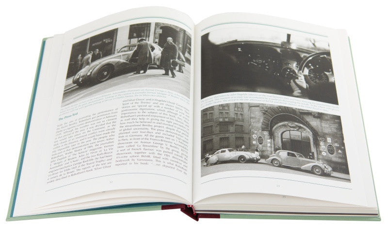Open hardcover book with black-and-white photo spreads and printed captions