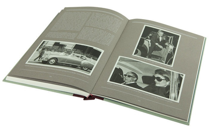 Open hardcover book with black-and-white car photos on printed pages