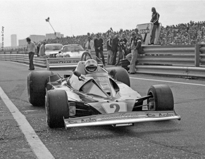 Motorsport book page showing a Formula 1 race car on a track