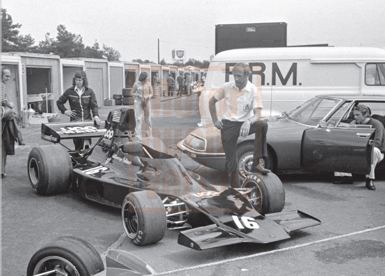 Motorsport book page with an open-wheel race car and crew members