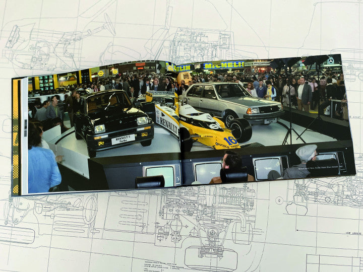 Automotive guidebook open to photo of multiple classic race cars on display