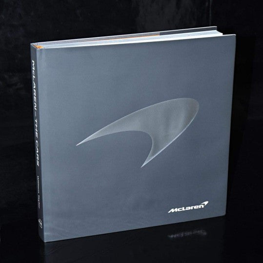 Hardcover book with McLaren logo on blue-gray cover, front view
