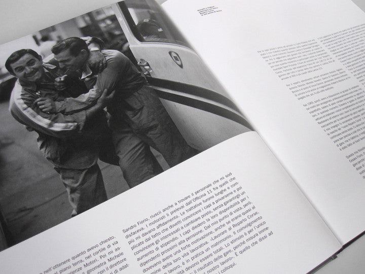 Automotive history book, open pages with black-and-white car photo and text