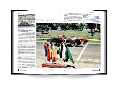 Racing history book open to an article with racing flags and track photo