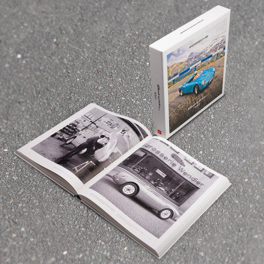 Open sports car photo book with black-and-white car photos on pages