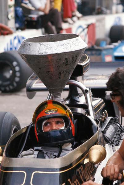 Formula 1 1970s book page with helmeted driver seated in open-wheel race car