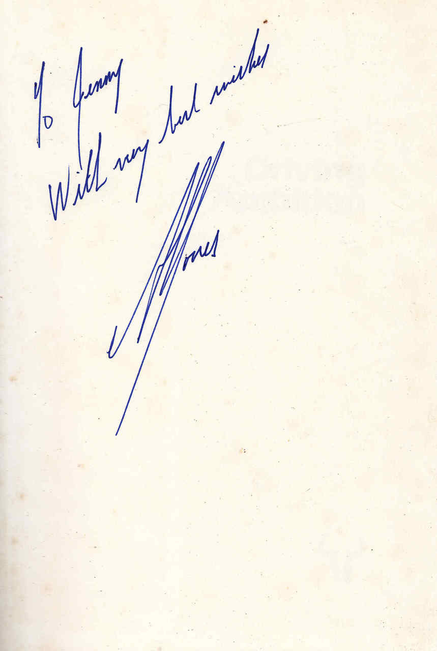 Signed Alan Jones Driving Ambition book with blue autograph on beige cover