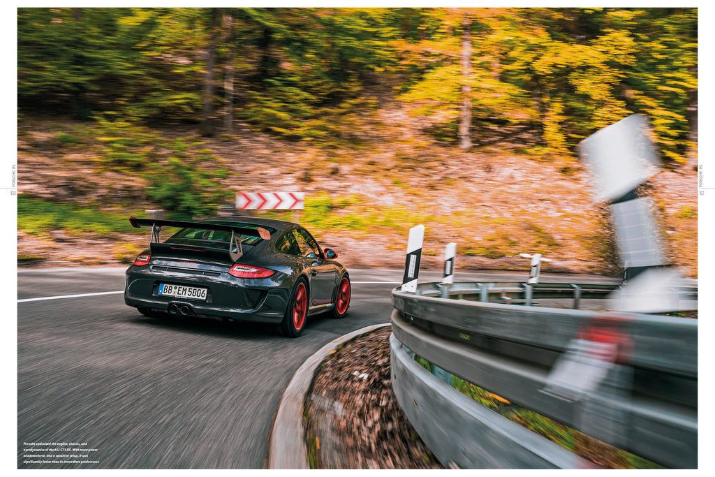 Black sports car driving on road beside a guardrail on book page