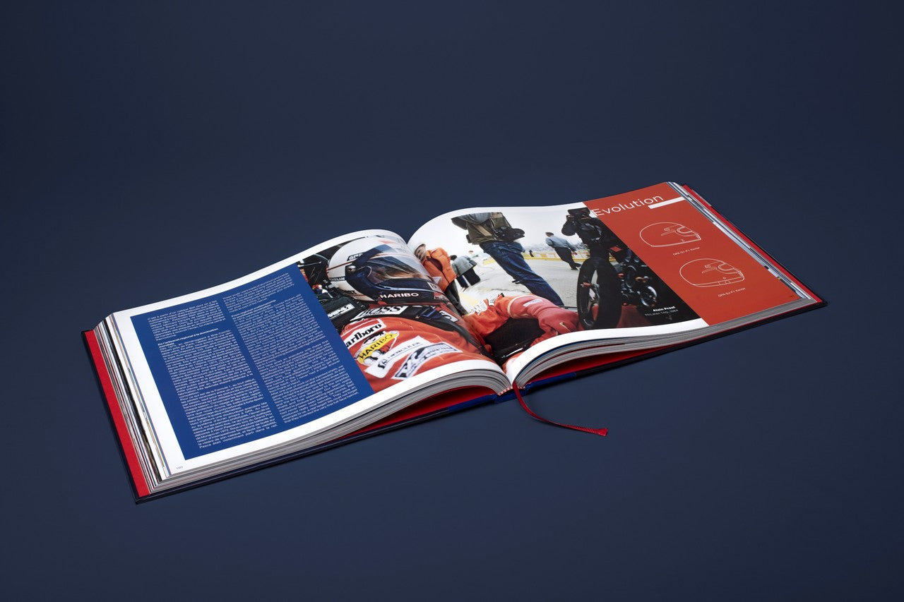 Opened helmet-themed book spread with racing photos across the left and right pages.