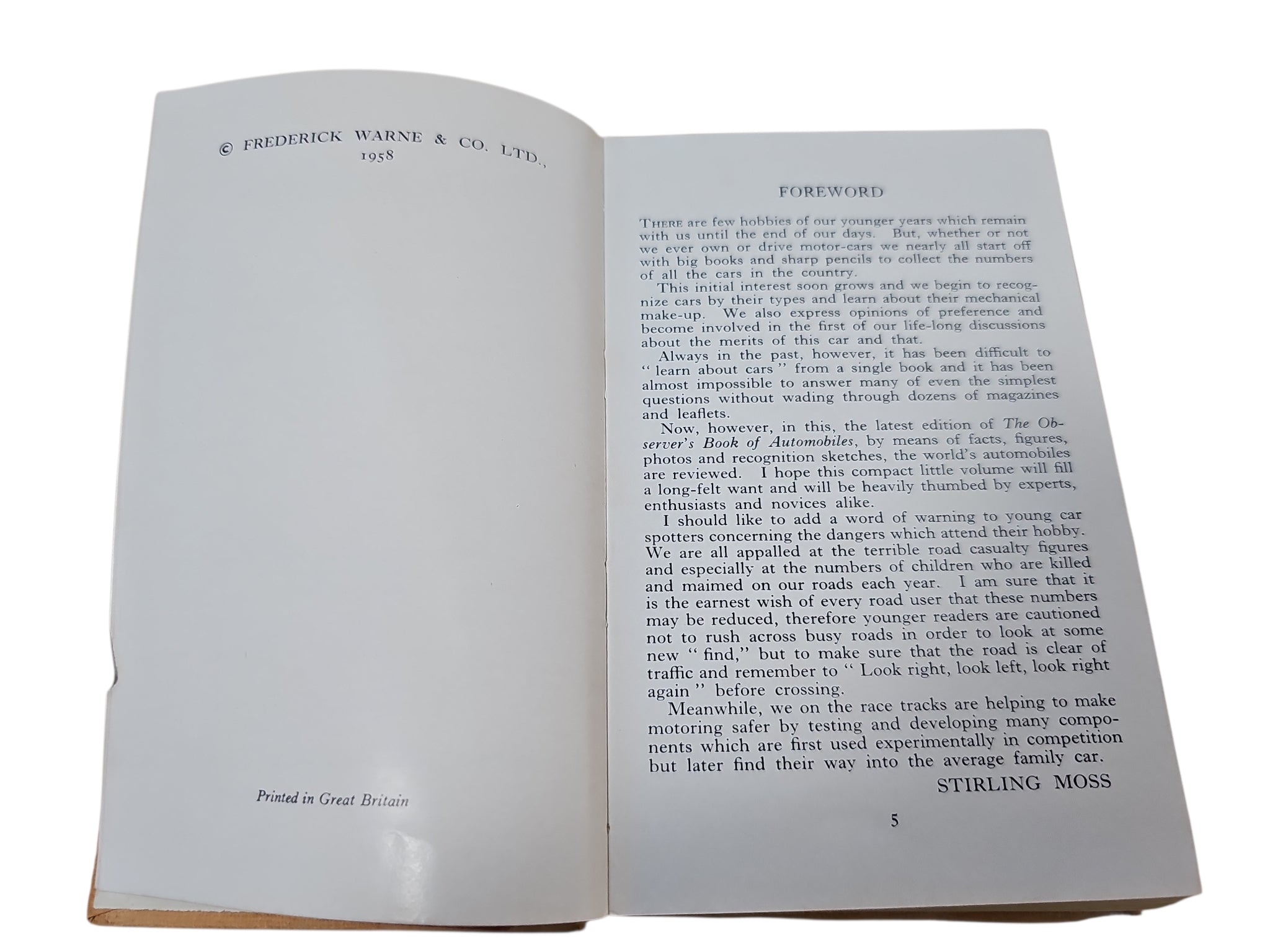 Open automobiles book with printed publisher info and paragraphs