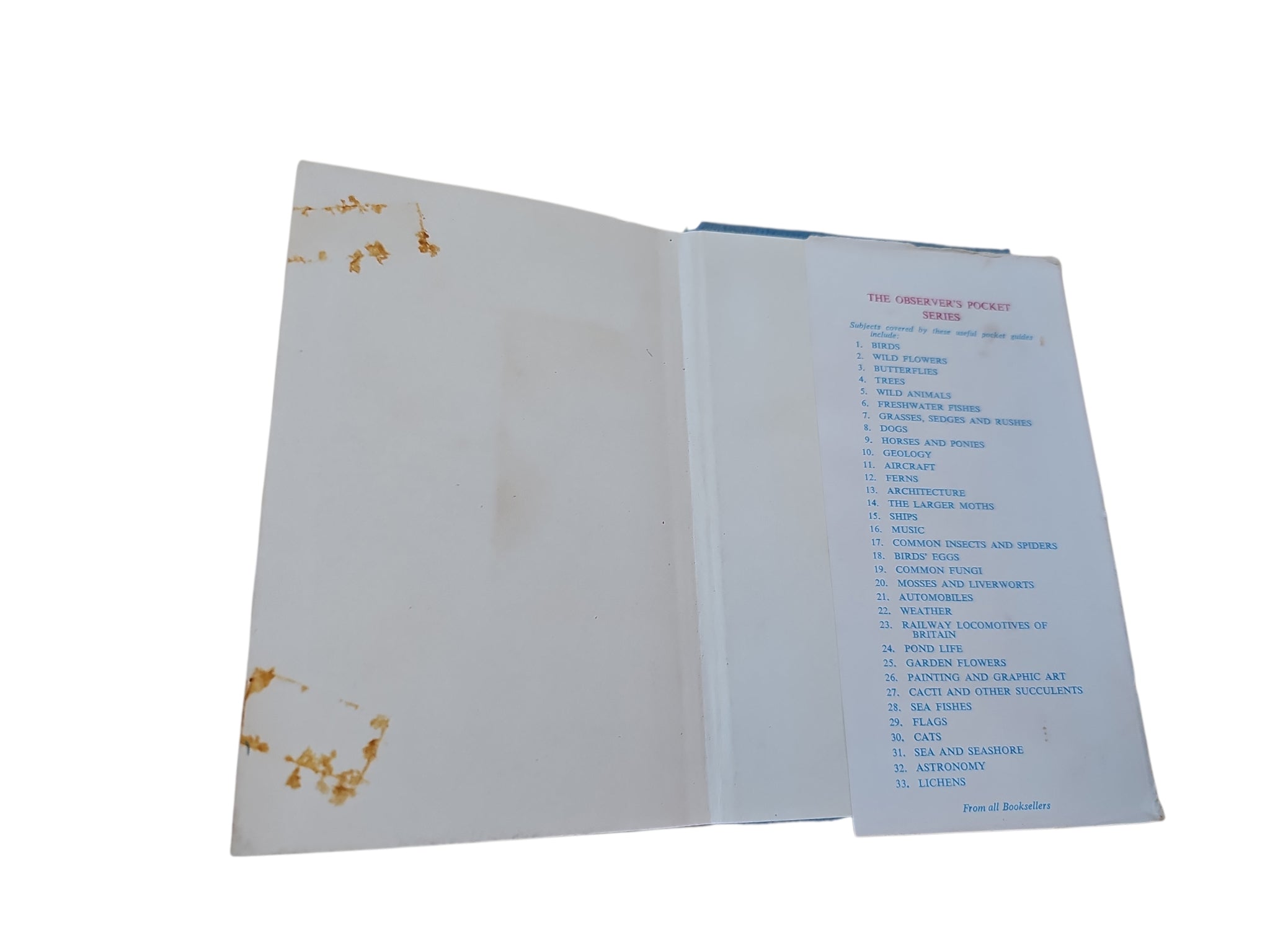 Opened book with light pages showing small decorative marks and a text list on right