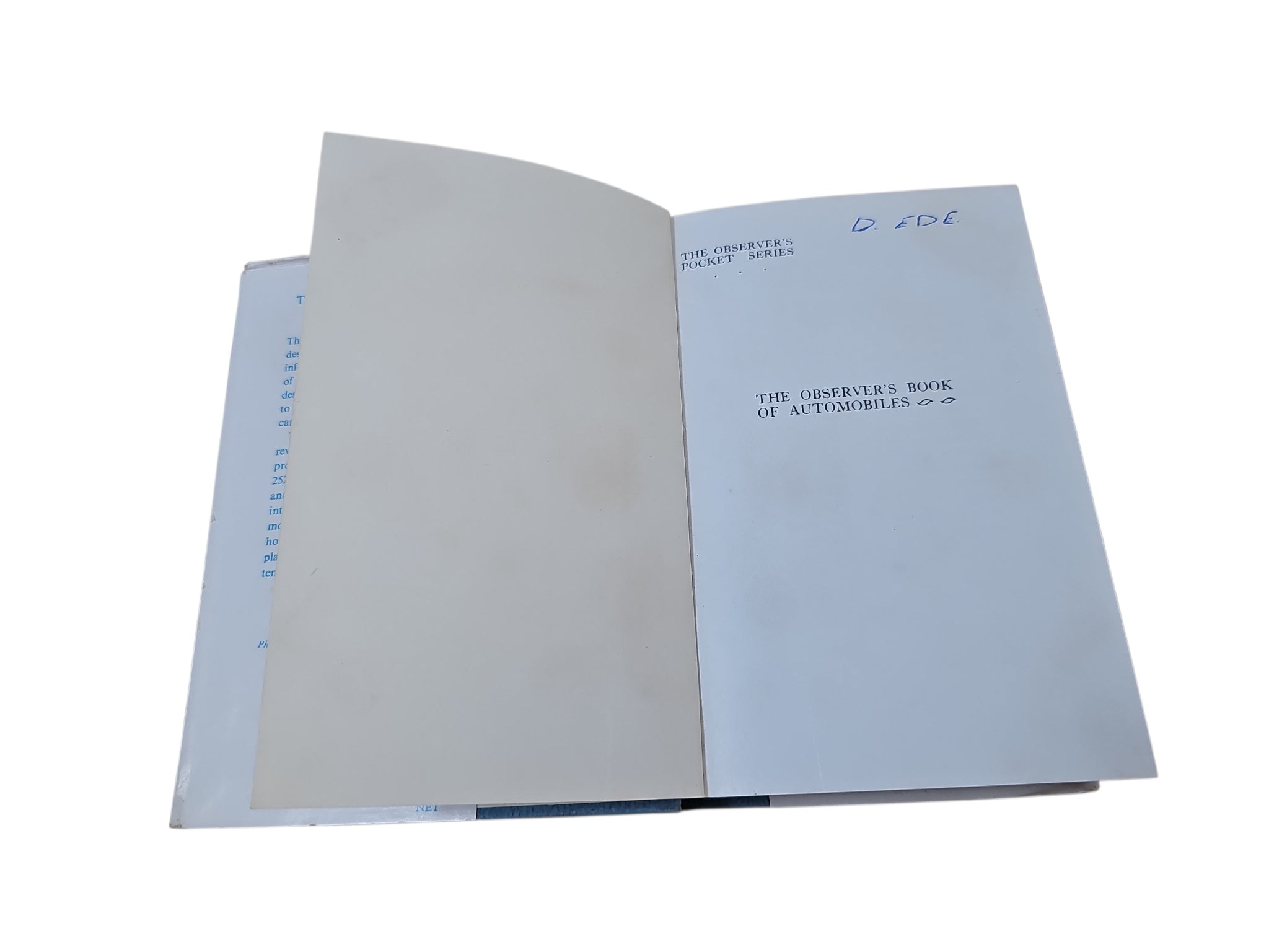 Open book with plain light-gray pages and printed title page, viewed from above