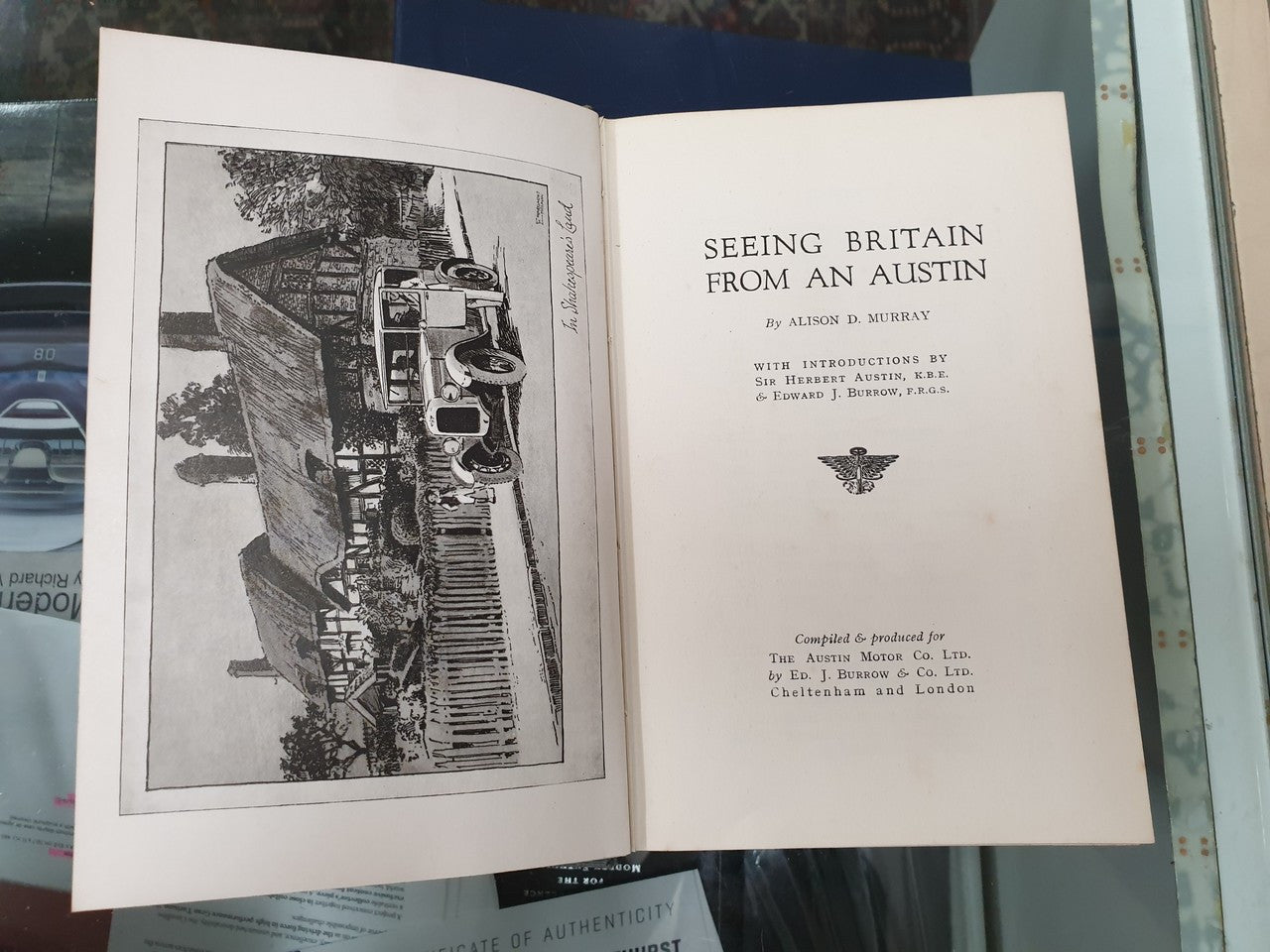 Open book with title page and black-and-white city illustration