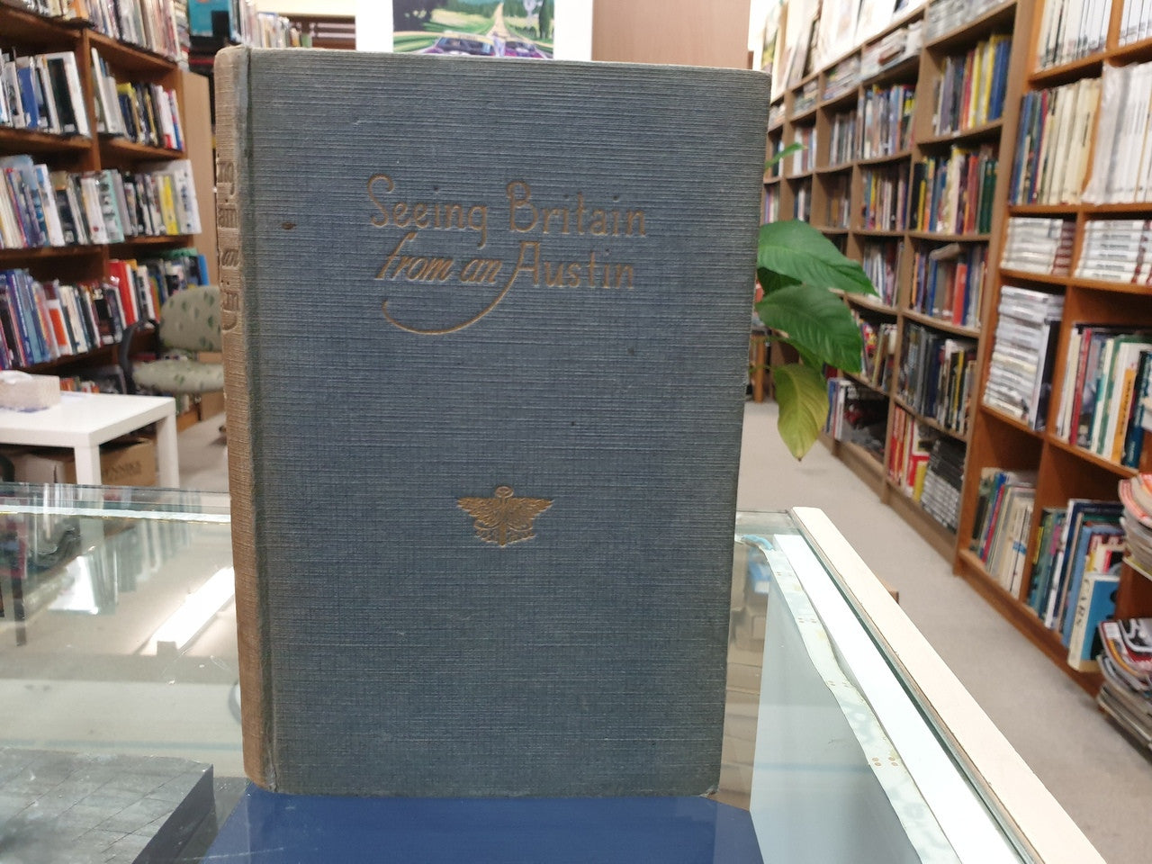 Hardcover book with blue cloth cover and gold title and emblem