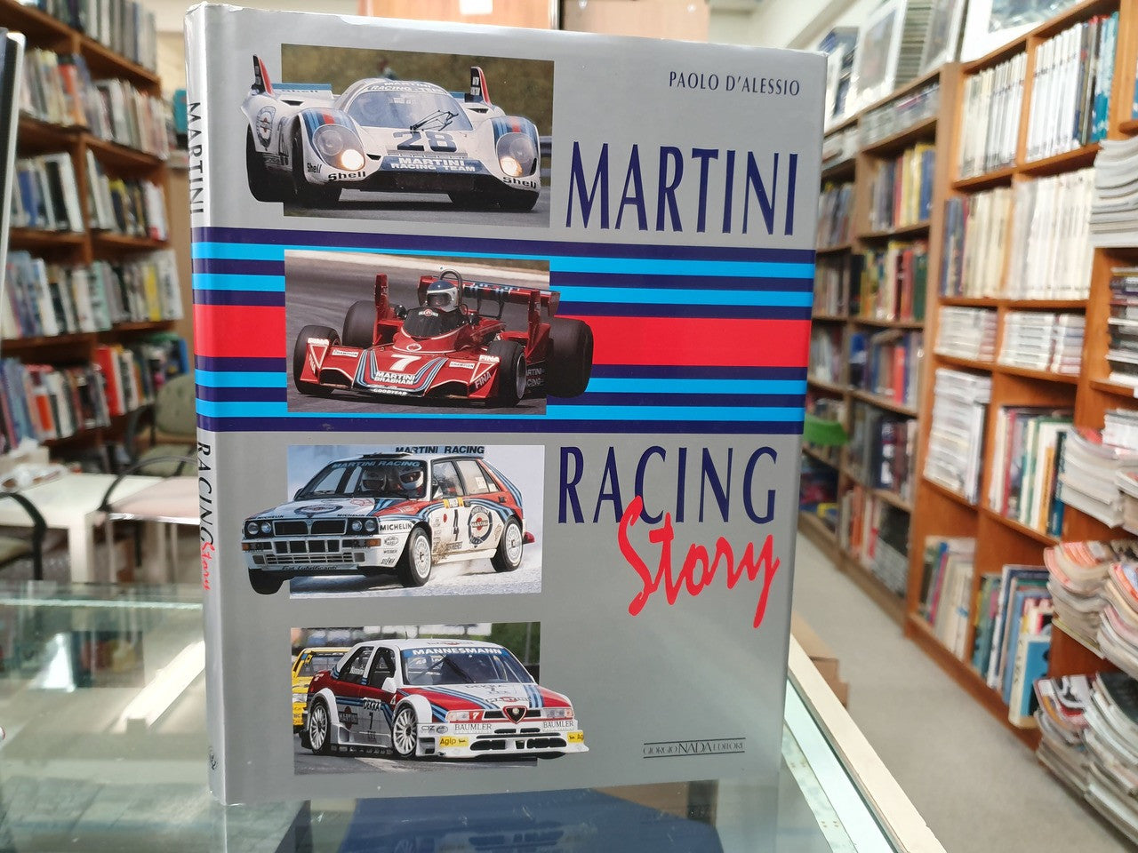 Hardcover racing story book front cover with Martini logo, stripes, and race cars