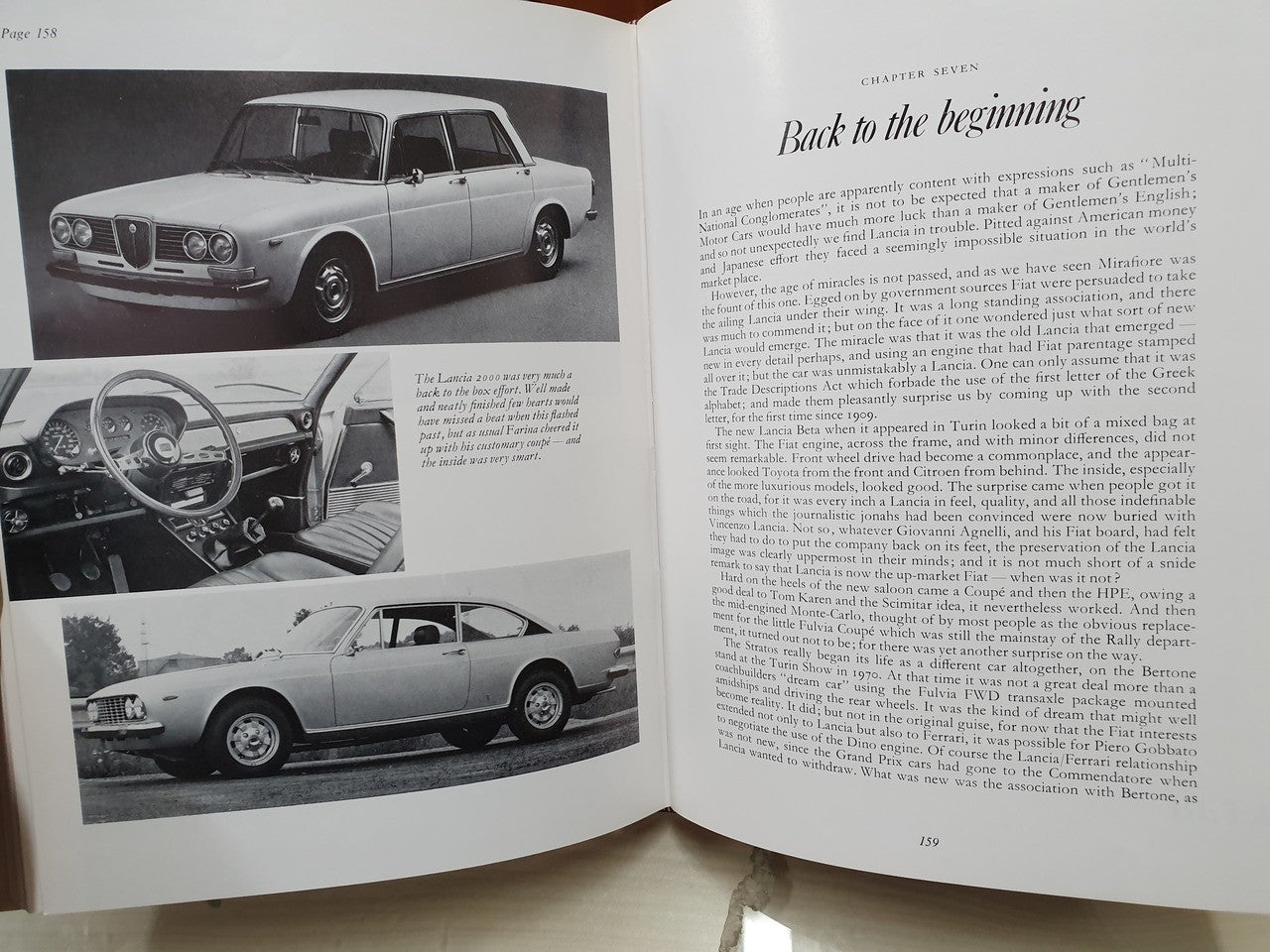 Open vintage racing book with multiple grayscale car photos and captions
