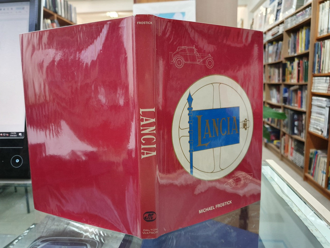Red book wrapper with LANCIA logo and Michael Frostick text