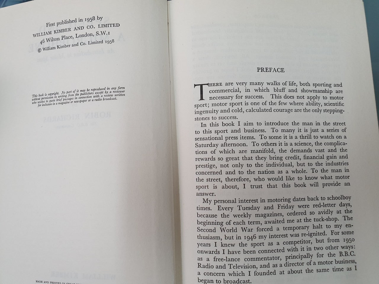 Hardcover book open to a preface page, two-sided printed text visible.