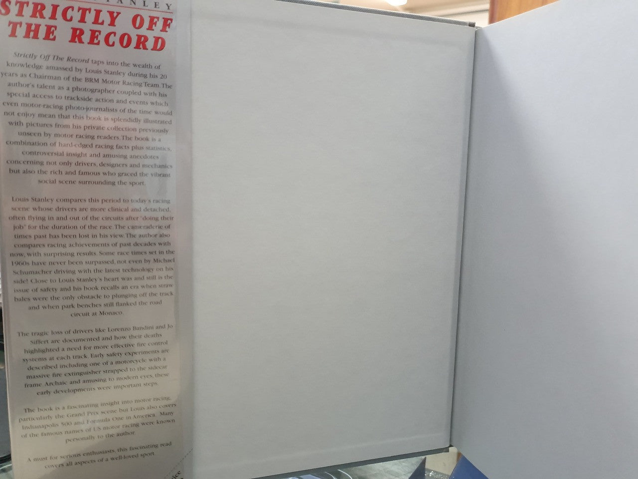 Open hardcover book with visible printed pages and dark spine