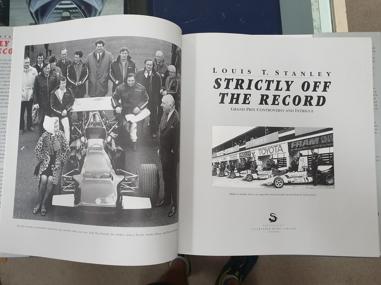 Hardcover book open to team group photo left and title page right