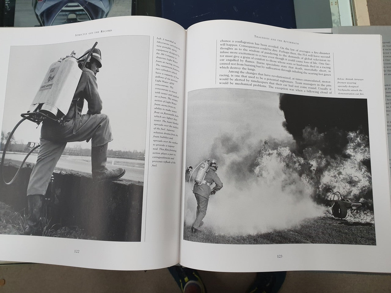 Hardcover book open to pages with outdoor black-and-white action photos