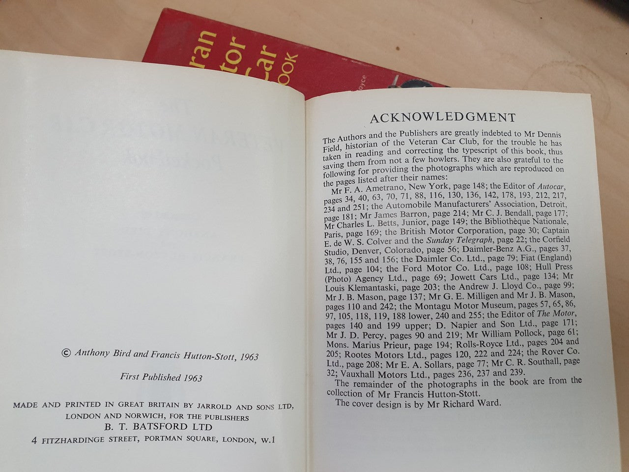 Open hardcover pocketbook with printed acknowledgements text and small page footer lines